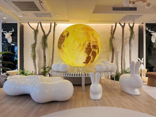 a room with white rabbits and a large orb at Finders Hotel Hualien Wen Hua in Hualien City