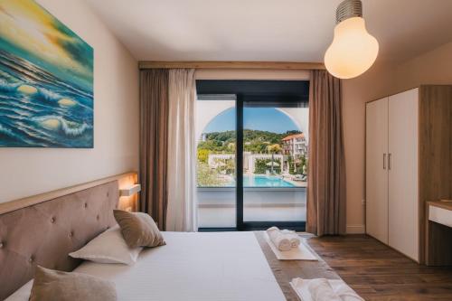 a bedroom with a bed and a large window at Apartments Stanaj in Ulcinj