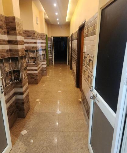 a hallway of a building with wooden floors and a door at SWAYAMSIDDHA continental in Kendrāparha