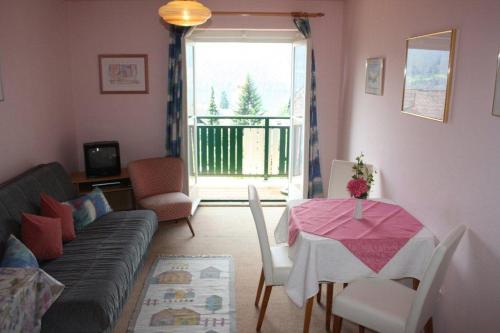 a living room with a table and a couch at Petersenhof in Millstatt