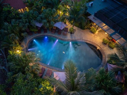 an overhead view of a swimming pool at night at Scenic Mountain Ecolodge Ninh Binh in Ninh Binh