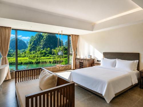 a bedroom with a large bed and a large window at The Dragons Rest Sanctuary-Yulong River Branch - Infinity Pool & Cafe - English Speaking Service - Free MTB Rental & Tailor-Made Tour Service in Yangshuo