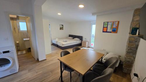 a living room with a table and a bed at Apartma Lana in Koper