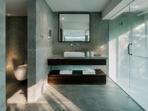 a bathroom with a sink and a mirror at The Dragons Rest Sanctuary-Yulong River Branch - Infinity Pool & Cafe - English Speaking Service - Free MTB Rental & Tailor-Made Tour Service in Yangshuo