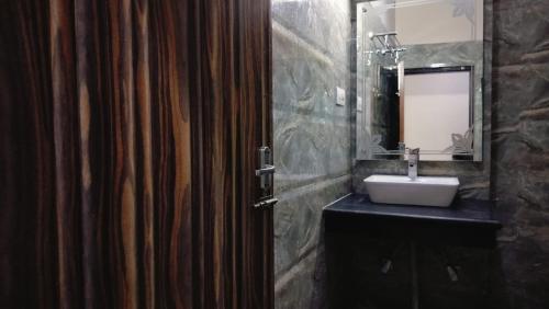 a bathroom with a sink and a mirror at Mcleodganj Mountain View Royal india-cheapest hotel in McLeod Ganj- Near Dalai Lama temple 100m-best hotel on Temple Road! in Dharamshala