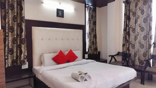 a bedroom with a large bed with red pillows at Mcleodganj Mountain View Royal india-cheapest hotel in McLeod Ganj- Near Dalai Lama temple 100m-best hotel on Temple Road! in Dharamshala