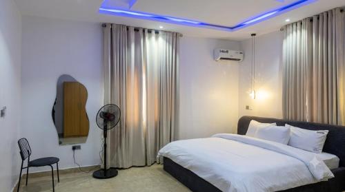 a bedroom with a bed and a tv in it at Three bedroom apartment Magodo GRA in Magodo