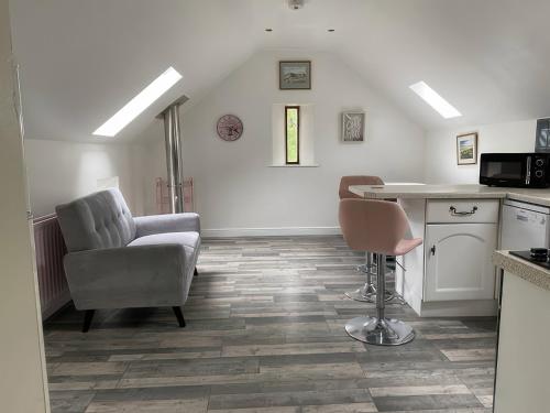a living room with a chair and a table at The Cottage in Middlesbrough
