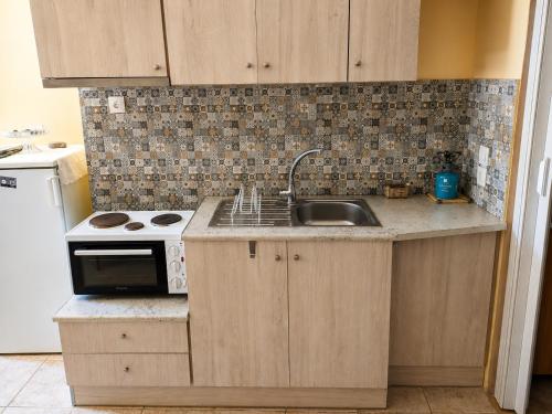 a kitchen with a sink and a stove at Elegant Studio in Chios near the Beach and Port in Chios