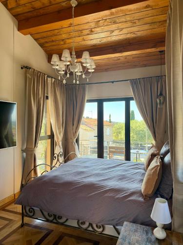 a bedroom with a bed with a large window at Escondida in Nice