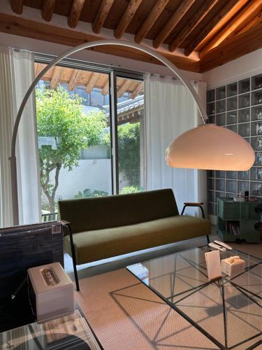 a living room with a couch and a glass table at Stay Jian in Daegu