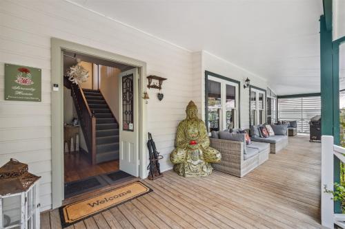 a home with a large statue sitting on the front porch at Serenity House Pemberton & Wellness Spa in Pemberton