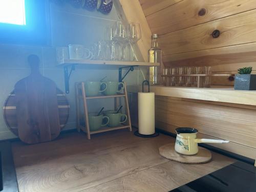 a room with a shelf with cups and a candle at Villa Aleksandra in Žabljak