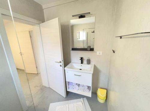 a bathroom with a sink and a mirror at Apartments Vicelić in Lovište
