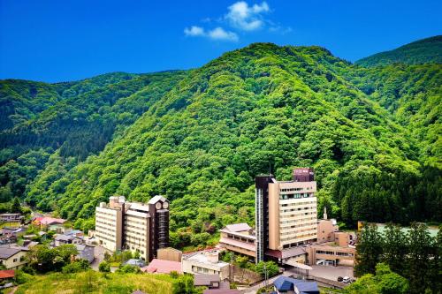 a view of a mountain with buildings and trees at Yuze Hotel in Kazuno