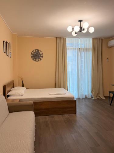 a bedroom with a large bed and a couch at Aqua Batumi 46 in Batumi