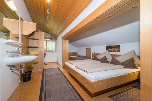 a small bedroom with a bed and a sink at Haus Gant in Sankt Gallenkirch