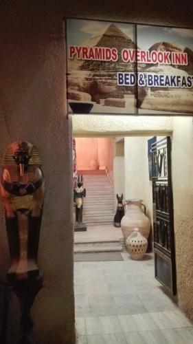 a view of a room with vases and a staircase at Pyramids Overlook Inn in Cairo