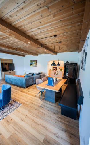 a living room with a table and a couch at Panorama Quartier Seefeld in Seefeld in Tirol