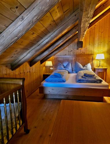 a bedroom with a large bed in a wooden room at DIRNDL Kammer in Abtenau