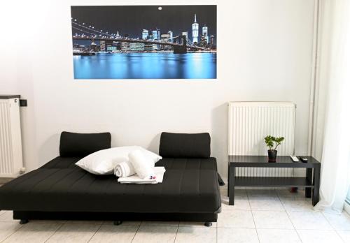 a bedroom with a bed with a city skyline in the background at Le Bel Appartement D'Antigoni in Alexandroupoli