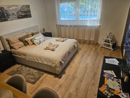 a bedroom with a bed with two towels on it at Borisz Apartman in Makó