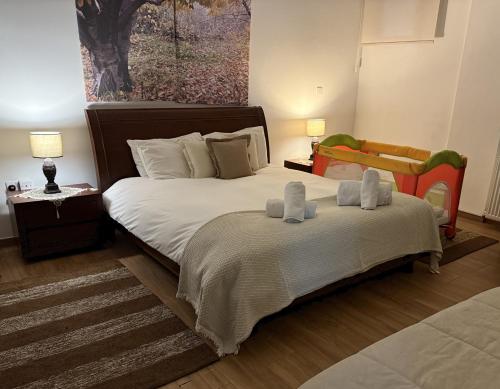 a bedroom with a bed with two towels on it at Ta Spitakia tis Theodosias in Kalopanayiotis