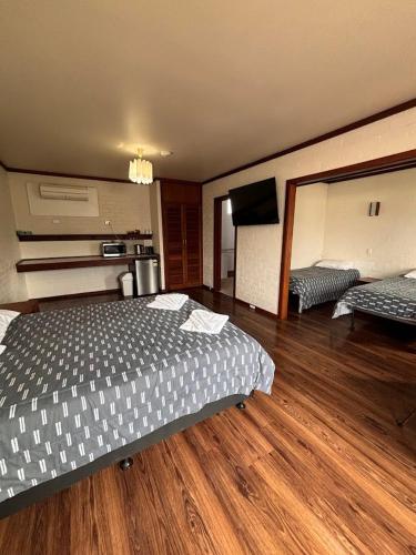 a bedroom with a bed and a flat screen tv at The Club Hotel Collie in Collie