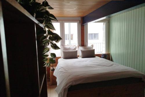 a bedroom with a bed and a large window at 20 Min nach Interlaken in Frutigen