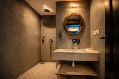 a bathroom with a sink and a mirror at The Belmonte House by Noventa - Rooftop Pool Hotel in Udaipur in Udaipur