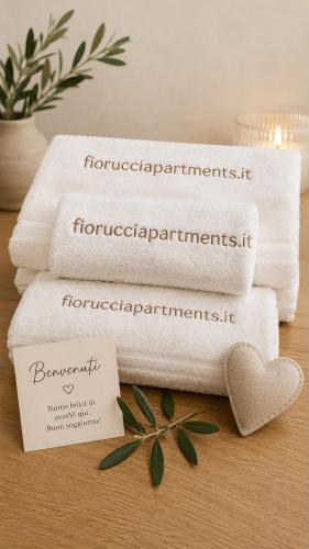 a pile of towels sitting on top of a table at Fiorucci Apartments - Veronica's House Fiumicino in Focene