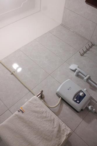 a towel holder on the floor in a bathroom at Crown Suites Motel in Masaka