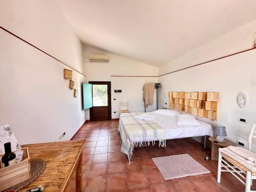 a bedroom with a bed and a wooden floor at Giardino dei Trulli Cummerse in Faccia di Trippa di Monte