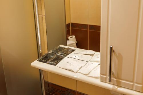 a bathroom with a sink and a mirror at Avenue Hotel in Chernivtsi