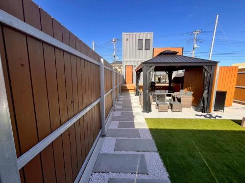 a backyard with a gazebo and a fence at Calme Villa in Asahi