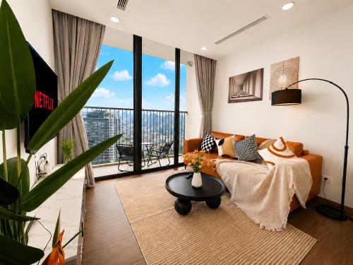a living room with a couch and a table at Eco Green Apartment Residence District 7 in Ho Chi Minh City