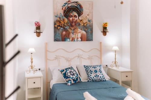 a bedroom with a large painting above a bed at Rinconcito in Almuñécar