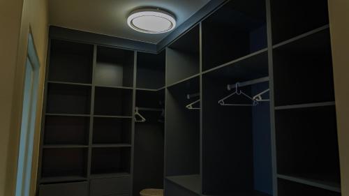 a bathroom with black walls and a ceiling with a light at Hillview Executive Self-Catering House in Blantyre