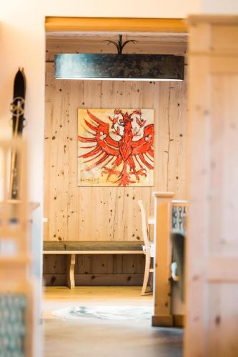 a room with a wooden wall with a painting on it at Hotel Garni Frommes in Fiss