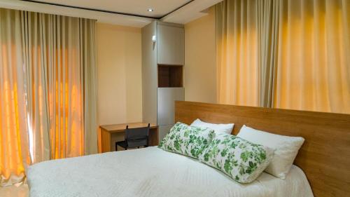 a bedroom with a bed with a pillow on it at Hillview Executive Self-Catering House in Blantyre