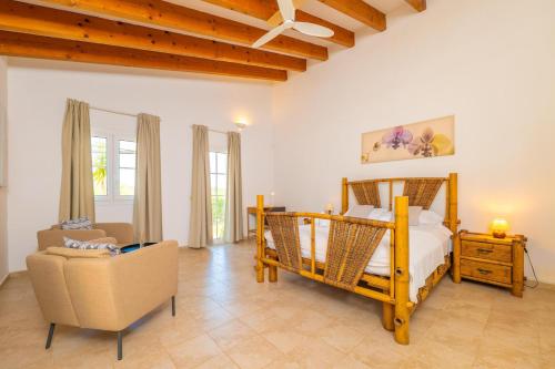 a bedroom with a bed and a chair in a room at Ca na Margalida in Manacor