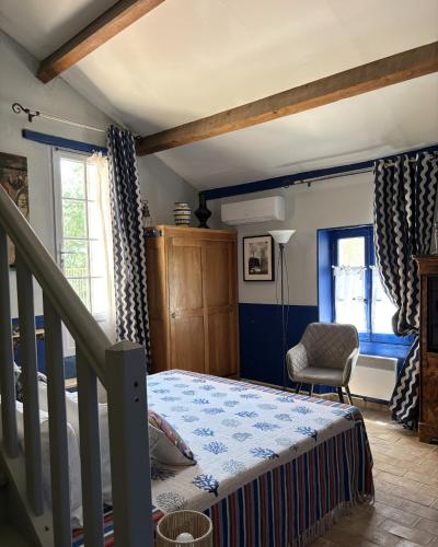 a bedroom with a bed and a stair case at Domaine du Commandeur in Mondragon