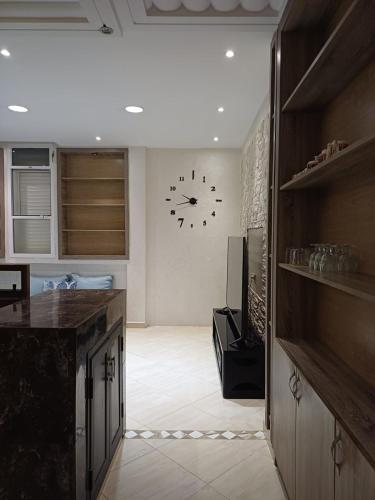 a kitchen with a large clock on the wall at Easy Stay Agadir in Agadir