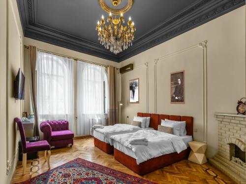 a bedroom with a bed and a chandelier at Old Money Boutique Hotel in Baku