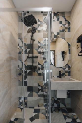 a bathroom with a shower with a sink and a mirror at Old Money Boutique Hotel in Baku