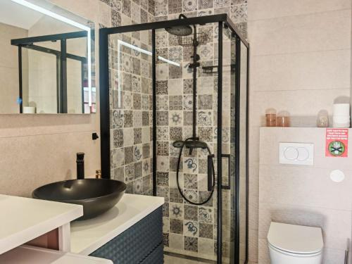 a bathroom with a sink and a shower at Stone Villa with sea view and pool in Smokvica