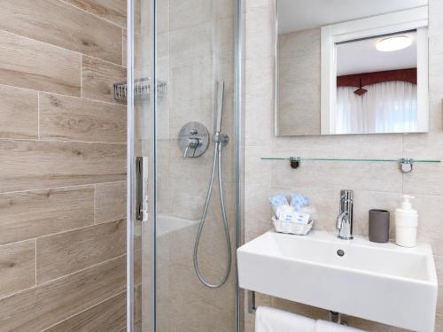 a bathroom with a shower and a sink at Hotel Da Mario in Caorle