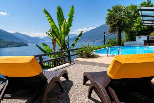 a couple of chairs sitting next to a swimming pool at Trebbiano Rubicone in Gravedona