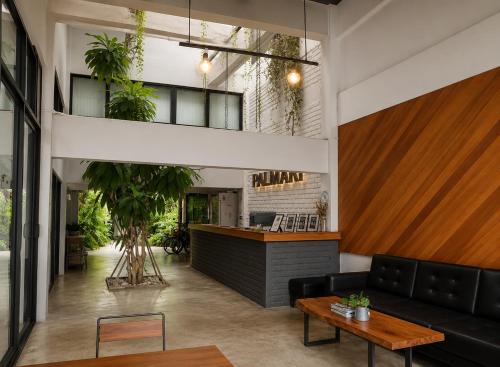 a living room with a couch and a bar at Palmari Boutique Hotel in Ban Nua Khlong