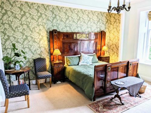a bedroom with a bed and a table and chairs at The Gables in Duddo